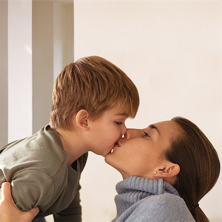 Mother kissing son, head and shoulders, side view Stock Photo - Premium Royalty-Free, Code: 632-01147933