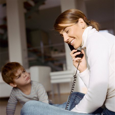 Son looking up at mother on phone Foto de stock - Sin royalties Premium, Código: 632-01147980