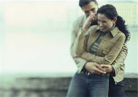 Couple embracing and laughing, blurred Stock Photo - Premium Royalty-Free, Code: 632-01148219