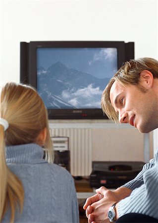 Father looking at daughter watching TV. Stock Photo - Premium Royalty-Free, Code: 632-01148273