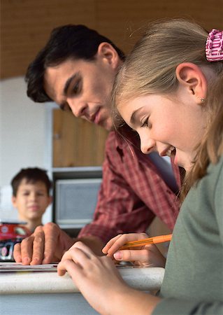 divorced family - Father helping daughter, son in background blurred. Stock Photo - Premium Royalty-Free, Code: 632-01148295