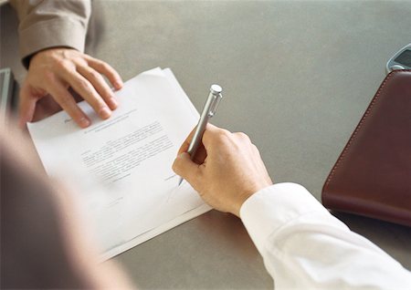 Businessperson signing paper. Stock Photo - Premium Royalty-Free, Code: 632-01148397