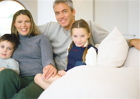 simsearch:632-02744723,k - Man, woman and two young children sitting together on couch, portrait Stock Photo - Premium Royalty-Free, Code: 632-01148409