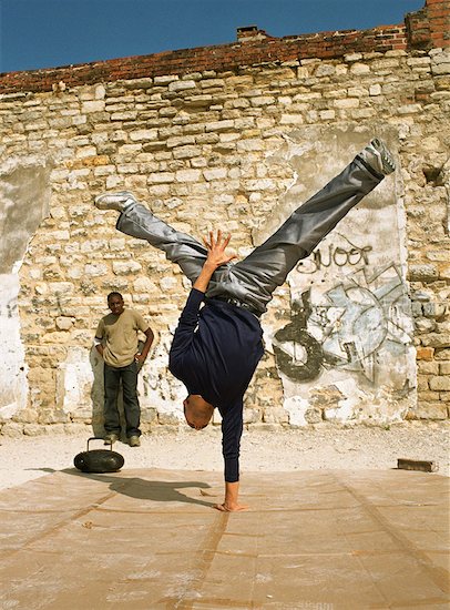 Man balancing on one hand, break dancing Stock Photo - Premium Royalty-Free, Image code: 632-01148543