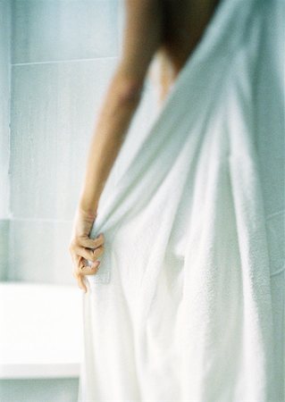 dry body towel - Woman putting on bathrobe, blurred, rear view. Stock Photo - Premium Royalty-Free, Code: 632-01148804