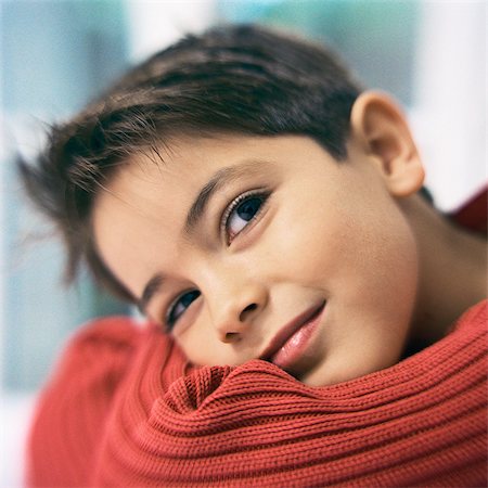 Boy smiling, head on arms, close-up Stock Photo - Premium Royalty-Free, Code: 632-01149415