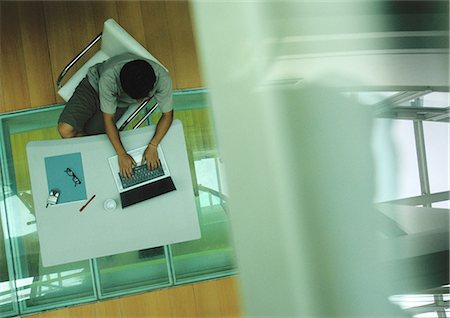 desk directly above - Man sitting at table, working on computer, view from above Stock Photo - Premium Royalty-Free, Code: 632-01149999
