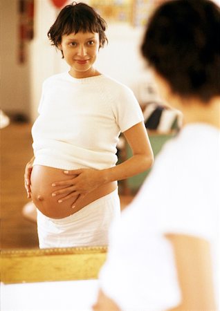 short haired women pregnant - Pregnant woman looking at herself in mirror Stock Photo - Premium Royalty-Free, Code: 632-01140039