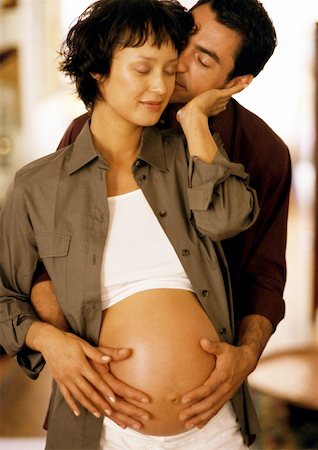 simsearch:632-01140071,k - Man touching pregnant woman's stomach from behind, eyes closed, portrait Foto de stock - Sin royalties Premium, Código: 632-01140072