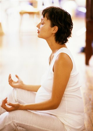 simsearch:632-01140106,k - Pregnant woman sitting in meditation position, side view Stock Photo - Premium Royalty-Free, Code: 632-01140093