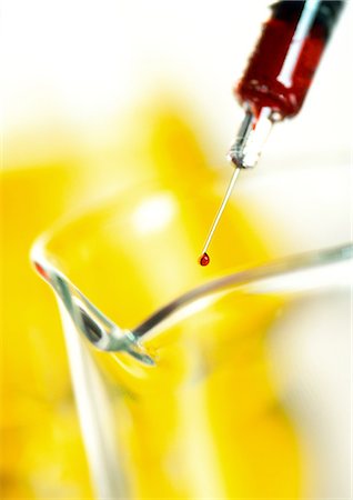 Syringe above glass flask, close-up Stock Photo - Premium Royalty-Free, Code: 632-01140524