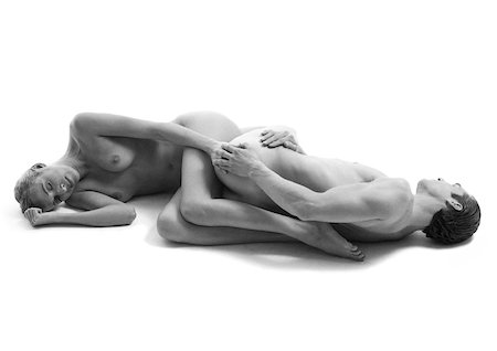 duo - Nude man and woman on floor lying with legs curled around each other's backs, holding hands, b&w Stock Photo - Premium Royalty-Free, Code: 632-01142522