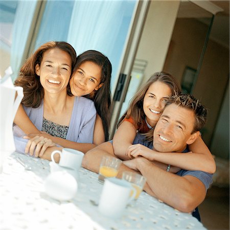 family teens terrace - Teenage girls embracing parents sitting at table Stock Photo - Premium Royalty-Free, Code: 632-01142629