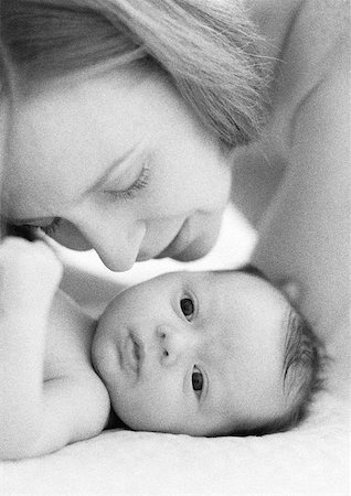 simsearch:632-01141193,k - Mother leaning over to kiss infant, close-up, b&w Foto de stock - Sin royalties Premium, Código: 632-01143039