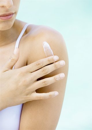 Woman applying cream to shoulder Stock Photo - Premium Royalty-Free, Code: 632-01154383