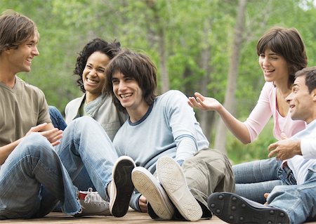 simsearch:695-03382465,k - Group of young friends sitting around together outdoors, laughing Stock Photo - Premium Royalty-Free, Code: 632-01154538