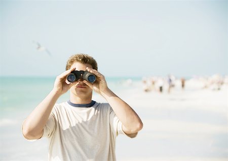 seagulls at beach - Man looking through binoculars on beach, facing camera Stock Photo - Premium Royalty-Free, Code: 632-01154714
