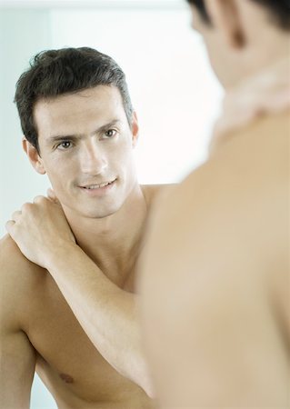 simsearch:632-01154783,k - Barechested man smiling at self in mirror Stock Photo - Premium Royalty-Free, Code: 632-01154739