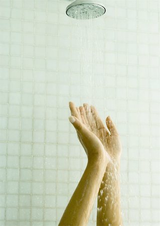 Woman holding up hands under shower Stock Photo - Premium Royalty-Free, Code: 632-01154905