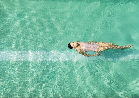 space with a person floating - Woman swimming in pool, full length Stock Photo - Premium Royalty-Free, Code: 632-01154927