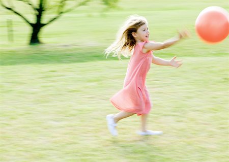 Girl chasing ball, blurred motion Stock Photo - Premium Royalty-Free, Code: 632-01154936