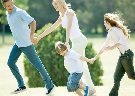 running forward - Family holding hands and running Stock Photo - Premium Royalty-Free, Code: 632-01154956