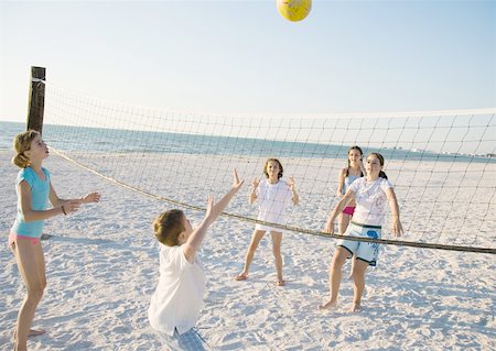 people playing volleyball on the beach - Group of kids playing beach volleyball Foto de stock - Sin royalties Premium, Código: 632-01155146