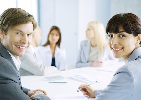 simsearch:632-01155400,k - Business meeting, man and woman smiling at camera Stock Photo - Premium Royalty-Free, Code: 632-01155377