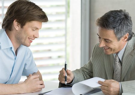 simsearch:632-01155457,k - Young man with mature business man, looking at document Stock Photo - Premium Royalty-Free, Code: 632-01155459