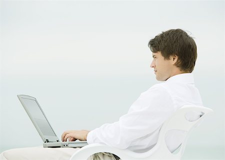 Man using laptop outdoors Stock Photo - Premium Royalty-Free, Code: 632-01155538