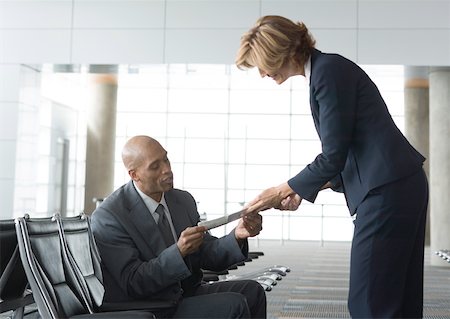 simsearch:695-03388701,k - Airline attendant handing seated businessman a ticket Stock Photo - Premium Royalty-Free, Code: 632-01155625