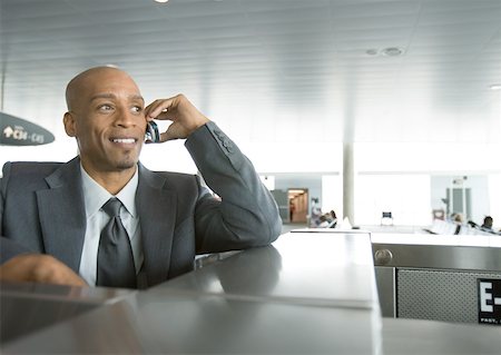 simsearch:695-03388701,k - Businessman using cell phone in airport Stock Photo - Premium Royalty-Free, Code: 632-01155627