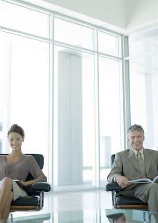 simsearch:632-01155400,k - Two business professionals sitting in office lobby, smiling at camera Stock Photo - Premium Royalty-Free, Code: 632-01155804