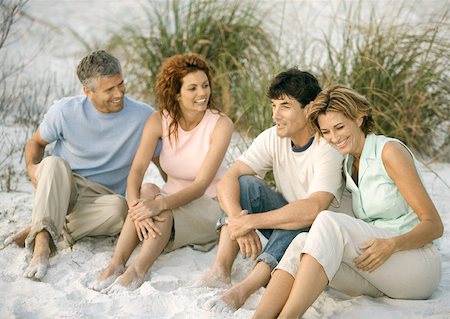 Two mature couples sitting in sand Stock Photo - Premium Royalty-Free, Code: 632-01156077