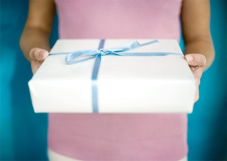 simsearch:649-06812641,k - Woman holding out gift, mid section Stock Photo - Premium Royalty-Free, Code: 632-01156345