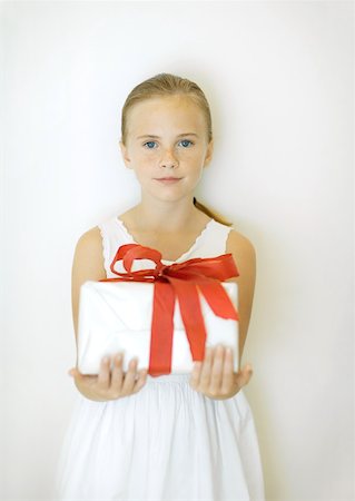 Girl holding present, front view Stock Photo - Premium Royalty-Free, Code: 632-01156353