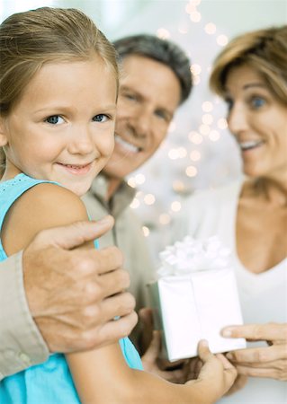 Little girl giving grandparents christmas present Stock Photo - Premium Royalty-Free, Code: 632-01156384