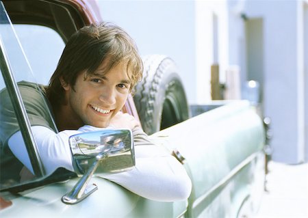 pick up truck and man - Young man in car, leaning on edge of car window frame Stock Photo - Premium Royalty-Free, Code: 632-01156393