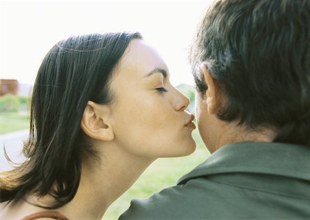 puckered lips profile - Woman kissing man's cheek Stock Photo - Premium Royalty-Free, Code: 632-01156432