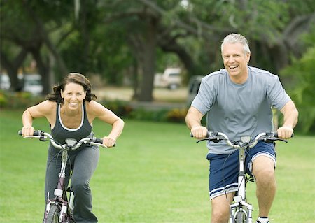 senior couple riding bicycles - Mature couple riding bikes, front view Stock Photo - Premium Royalty-Free, Code: 632-01156462