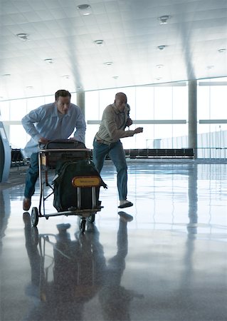 simsearch:695-03388701,k - Travelers hurrying though airport Stock Photo - Premium Royalty-Free, Code: 632-01156503