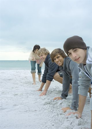 Young adult friends about to race on beach Stock Photo - Premium Royalty-Free, Code: 632-01156600