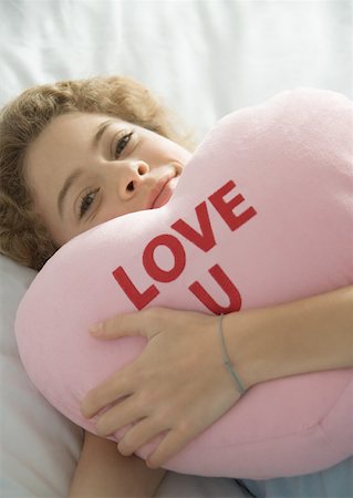 simsearch:693-06379441,k - Preteen girl holding heart pillow Stock Photo - Premium Royalty-Free, Code: 632-01156699