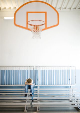 simsearch:614-08872791,k - Teenage boy sitting alone with head down in school gym Fotografie stock - Premium Royalty-Free, Codice: 632-01156745