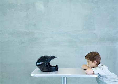 pic of person head down arms crossed - Boy leaning on table, facing helmet Stock Photo - Premium Royalty-Free, Code: 632-01156910