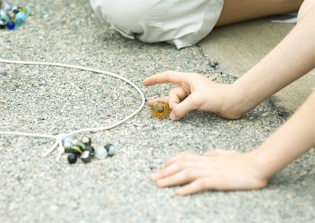 Children playing marbles on asphalt Stock Photo - Premium Royalty-Free, Code: 632-01156971