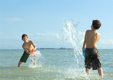 friends and buckets - Two boys splashing in water at beach Stock Photo - Premium Royalty-Free, Code: 632-01156987
