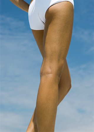 simsearch:632-05991314,k - Woman standing in sun, close-up of legs Stock Photo - Premium Royalty-Free, Code: 632-01157190