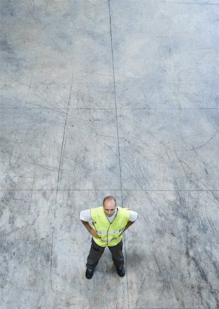 simsearch:632-01157373,k - Factory worker standing with hands on hips, high angle view Fotografie stock - Premium Royalty-Free, Codice: 632-01157364