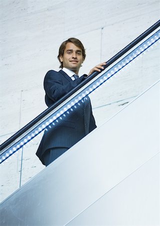 simsearch:695-03382908,k - Businessman going up on escalator Fotografie stock - Premium Royalty-Free, Codice: 632-01157412